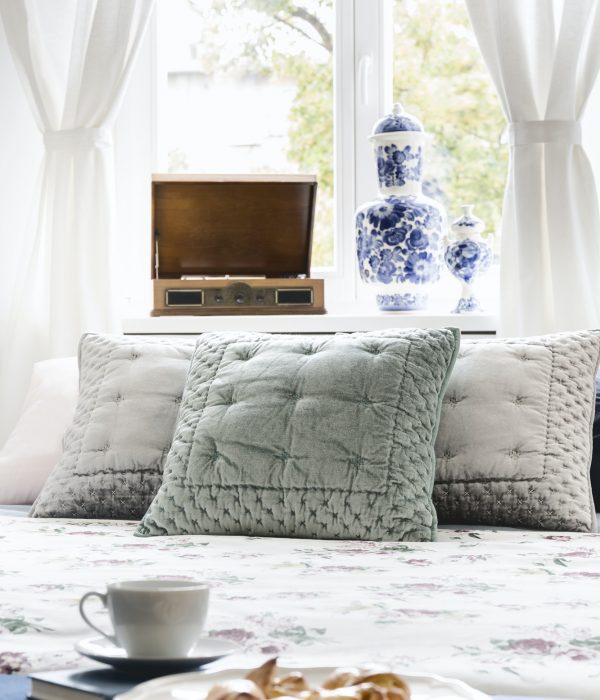 Close-up of a sweet breakfast on a bed in a stylish bedroom inte